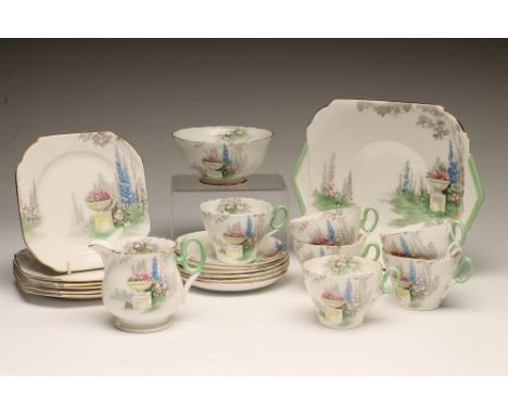 AN ART DECO SHELLEY CHINA TEA SERVICE printed in grey and overpainted in pink, yellow, blue and green with the "Urn" pattern 