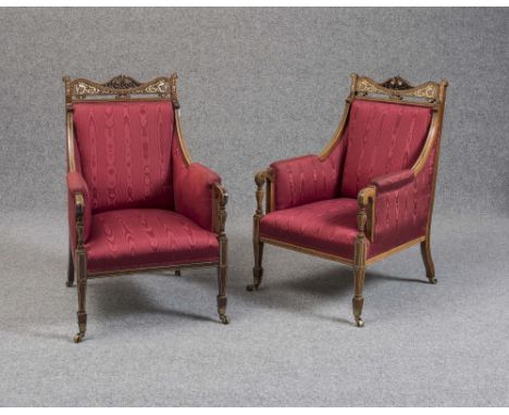 A PAIR OF EDWARDIAN ROSEWOOD SALON ARMCHAIRS upholstered in maroon watered silk, arched crest rail pierced with foliate scrol