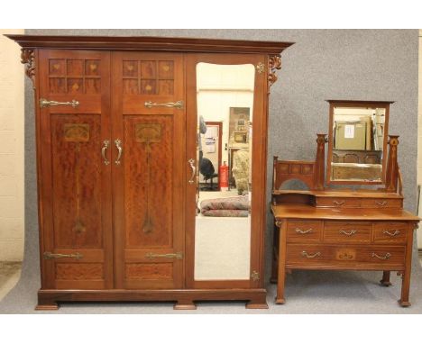 A MAPLE &amp; CO ART NOUVEAU INLAID MAHOGANY PART BEDROOM SUITE comprising triple wardrobe, the moulded cornice over two mult