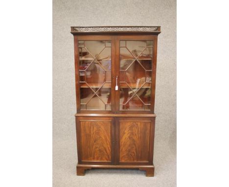 A GEORGIAN DESIGN MAHOGANY TWO STAGE BOOKCASE, late 19th century, the moulded cornice with pierced fret surmount, two astraga