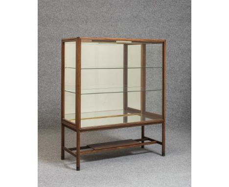 A SCANDINAVIAN ROSEWOOD DISPLAY CABINET, 1970's, of oblong form, the moulded frame with rounded corners and ebony tablet fini