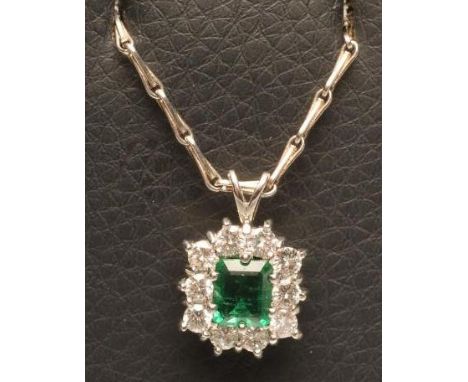 AN EMERALD AND DIAMOND PENDANT, the square cut emerald claw set to a border of ten round brilliant cut diamonds to an 18ct wh