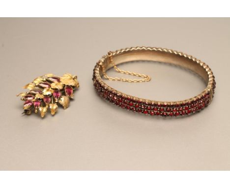 A VICTORIAN ALMANDINE GARNET SPRAY BROOCH, the nine graduated tear cut stones close set to a matt leaf frame, unmarked, 1 1/2