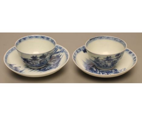 A PAIR OF NANKING CARGO PORCELAIN TEA BOWLS AND SAUCERS painted in underglaze blue with landscapes, saucers 4" diameter, bear