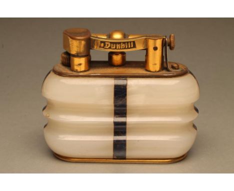 A DUNHILL WHITE ONYX TABLE LIGHTER of ribbed oblong form inset with lapis lazuli angles, gilt metal mounts, 3 3/4" wide (Est.