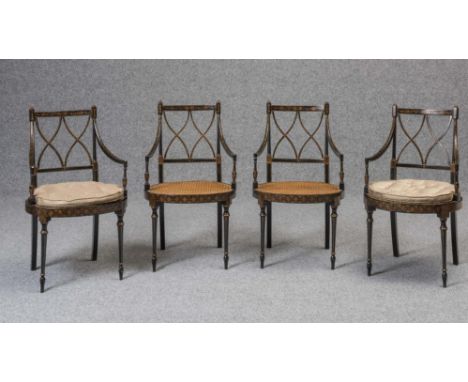 A SET OF FOUR REGENCY STYLE CANED AND PAINTED ELBOW CHAIR, 20th century, gilded with foliage on a black ground, the open trel