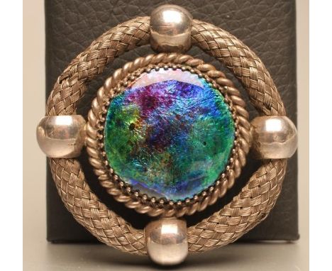 AN EDWARDIAN SILVER CELTIC STYLE BROOCH, maker Charles Horner, Chester 1910, of open circular form with central blue/green en