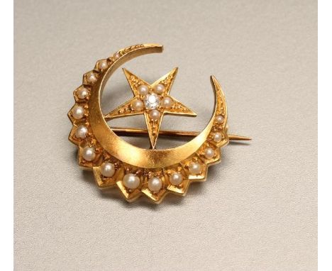 A VICTORIAN 18CT GOLD AND SEED PEARL CRESCENT BROOCH, centred by a star set with an old mine cut diamond and five further see