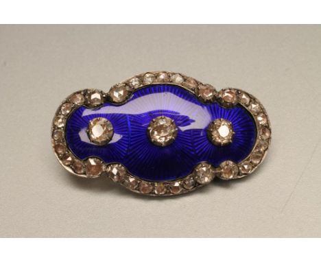 A VICTORIAN DIAMOND AND ENAMEL BROOCH, the blue guilloche quatrefoil panel centred by three close back set old mine cut stone