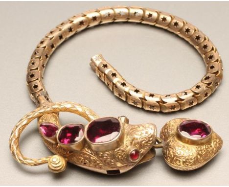 A VICTORIAN SNAKE BRACELET, the foliate engraved head with ruby eyes, close back set with a tear cut and two cushion cut alma