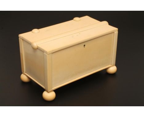 A SECTIONAL IVORY BOX, 19th century, of plain oblong form raised upon four bun feet, the hinged cover with button mounts, box