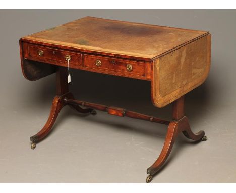 A REGENCY MAHOGANY SOFA TABLE of rounded oblong form with satinwood banding and stringing, two frieze drawers with brass ring