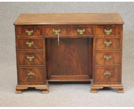 A GEORGIAN DESIGN MAHOGANY KNEEHOLE DESK, late 19th century, the moulded edged and banded top with cusped corners, frieze dra