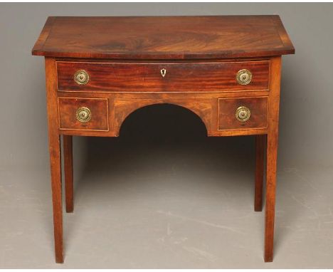 A GEORGIAN MAHOGANY DRESSING TABLE, c.1800, of mildly bowed form, the flame figured top with rosewood banding and stringing, 