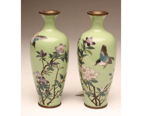 A PAIR OF JAPANESE CLOISONNE ENAMEL VASES of baluster form, inlaid in lilac, green and blue with finches flying amidst flower