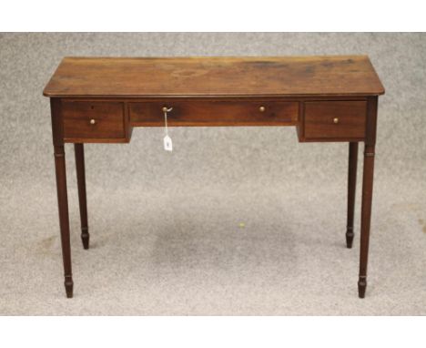 A REGENCY MAHOGANY KNEEHOLE WRITING/DRESSING TABLE of rounded oblong form with reeded edged top, long shallow frieze drawer f