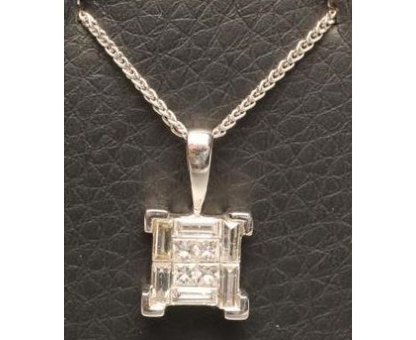 A MODERN DIAMOND PENDANT, the four central square cut stones within a border of six baguette cut stones, all channel set to a