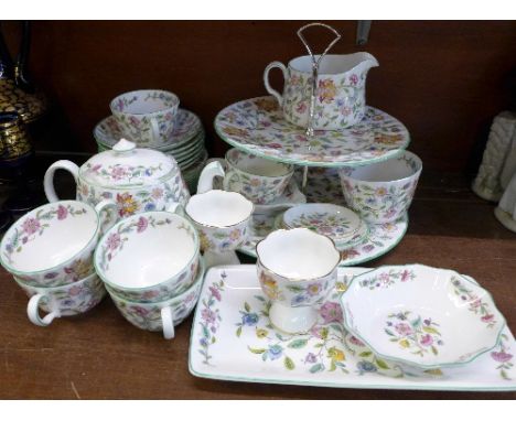 A Minton Haddon Hall six setting tea set with teapot, cream and sugar, two tier cake stand and other dishes, thirty pieces in