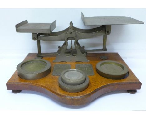 A set of 19th Century Post Office scales and weights on an oak base
