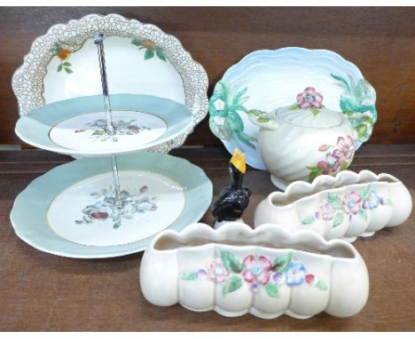 Clarice Cliff pottery including a pair of planters, wavy edge dish, cake stand, a lidded pot, a Staffordshire dish and a pie 