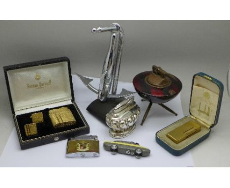 A collection of lighters including Dunhill, Norman Hartnell design, Sarome Bluebird, Ronson, Roland, chrome in the shape of a