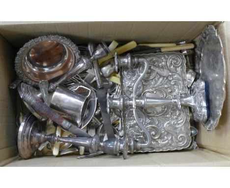 A collection of plated ware;- two trays, candelabra, a pair of candlesticks, flatware, etc.