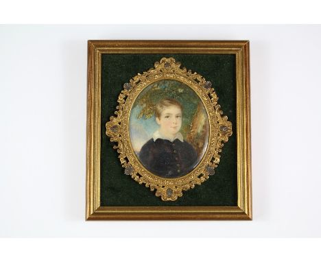 A 19th Century Oval Portrait Miniature depicting a Young Gentleman, approx 6.5 x 8 cms, velvet mount, framed.