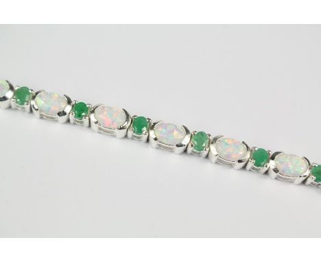 A Silver Opal and Emerald Bracelet, approx 17 cms, approx 13.5 gms, set with fifteen oval opals approx 5 x 3 mm and sixteen e