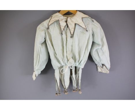 A Pale Blue and White Silk Jester's Costume; the medium size costume has a white collar with metal bells and grey braid, the 