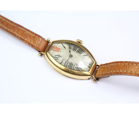 An 18ct Yellow Gold Wrist Watch. The watch having an oblong face with Roman dial, case bearing import marks, stamped 18ct, wa