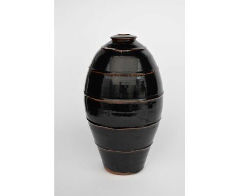 Φ Phil Rogers (1951-2020)a ribbed stoneware bottle, covered to the foot in a rich tenmoku glazeimpressed seal mark, 43.5cm. h