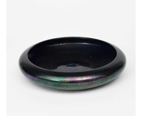 A Ruskin Pottery floating bowl by William Howson-Taylor, dated 1922, covered in a petrol lustre glaze, a smaller Ruskin Potte