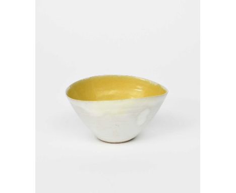 Φ Dame Lucie Rie (1902-1995)a stoneware elliptical bowl, glazed yellow to the interior, the exterior pale grey,impressed seal