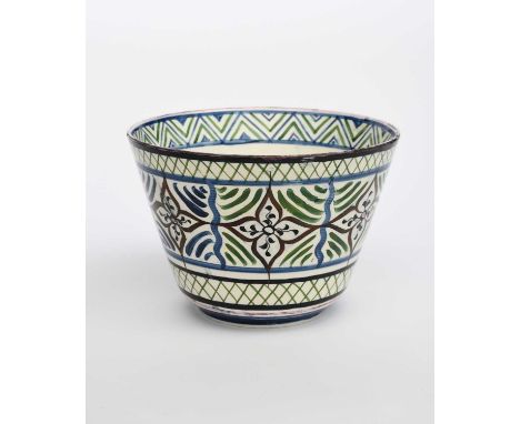 A Wedgwood Pottery deep bowl by Alfred Powell, flaring conical form on a shallow foot, painted with stylised flowerheads and 