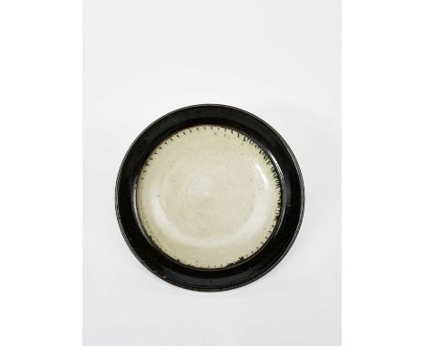 Richard Batterham (1936-2021)a large and impressive stoneware plate with chatter band, covered with an ash glaze, the rim bla