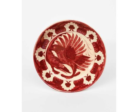 A William De Morgan small charger by Fred Passenger, painted to the well with an eagle and crocodile fighting, in ruby lustre