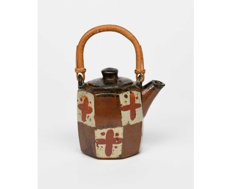 Φ John Maltby (1936-2020)an early stoneware teapot and cover, facetted form, painted with panels in colours, with overslung b