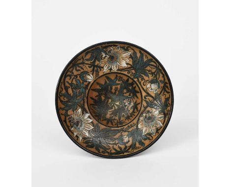 A Martin Brothers stoneware wall plate by Robert Wallace Martin, dated 1891, painted with a frieze of passion flowers and fol