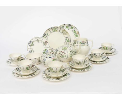 A charming Wedgwood Pottery tea set for six by Alfred Powell, pattern no.5573, painted with panels of English wild flowers, i