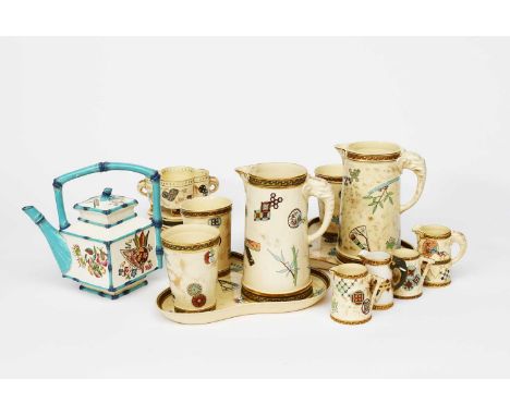 A Royal Worcester Aesthetic Movement water set, comprising jug, two beakers and a tray, printed and enamelled with panels of 