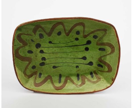 David Leach OBE (1911-2005)a slip-trailed dish, in ochre and brown on a green ground,impressed DL seal mark40.5cm. wide 