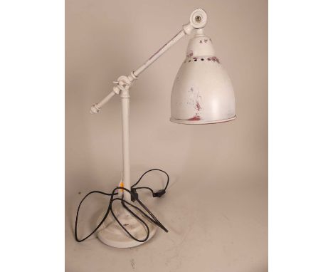 A contemporary white painted table lamp, having an adjustable shade and arm, h.55cm 
