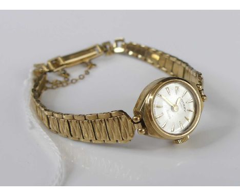 A lady's Rotary 9ct gold cased manual wind wristwatch, having 21-jewel mechanical movement and on gold bracelet, gross weight