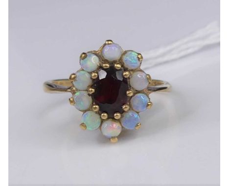 A 9ct gold, garnet and opal set flower-head cluster ring, 3g, size N
