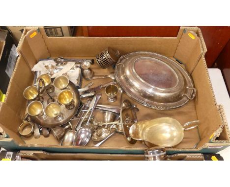 A collection of silver plated wares to include an entree dish, helmet shaped sauce boat and flat wares