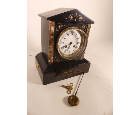A Victorian black slate mantel clock, the enamelled dial showing Roman numerals and twin winding holes for an eight-day movem