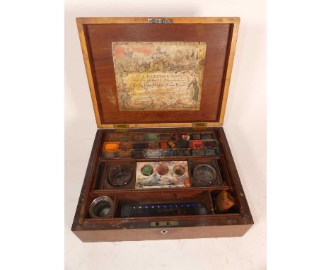 A 19th century mahogany artist's box, the hinged lid opening to reveal a fitted interior and contents, bearing a label for W.