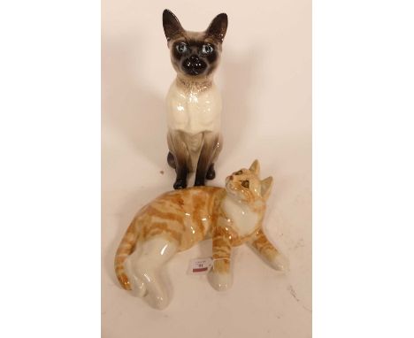 A Beswick pottery figure of a Siamese cat, modelled seated, h.35cm; together with a Winstanley style pottery figure of a recu