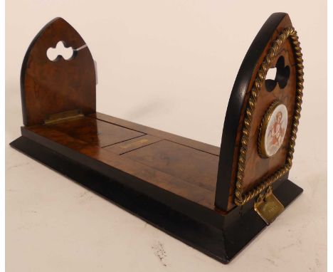 A George Betjeman &amp; Sons patent adjustable book-slide, circa 1880, walnut with applied painted porcelain roundels, closed
