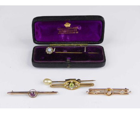 An early 20th century 15ct gold, peridot and seed pearl set bar brooch, 2g; together with two 9ct gold bar brooches, both wit